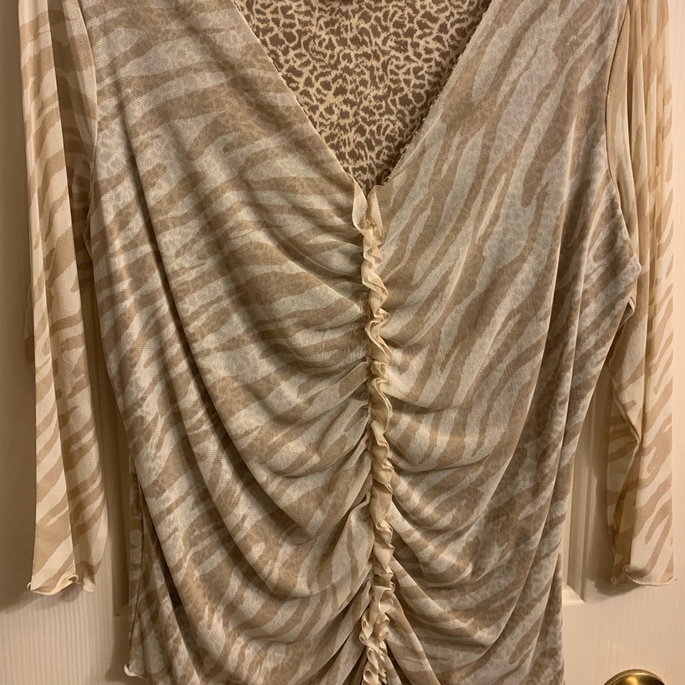 i.e. brand tasteful animal print blouse w/small ruffles down the middle. Size L